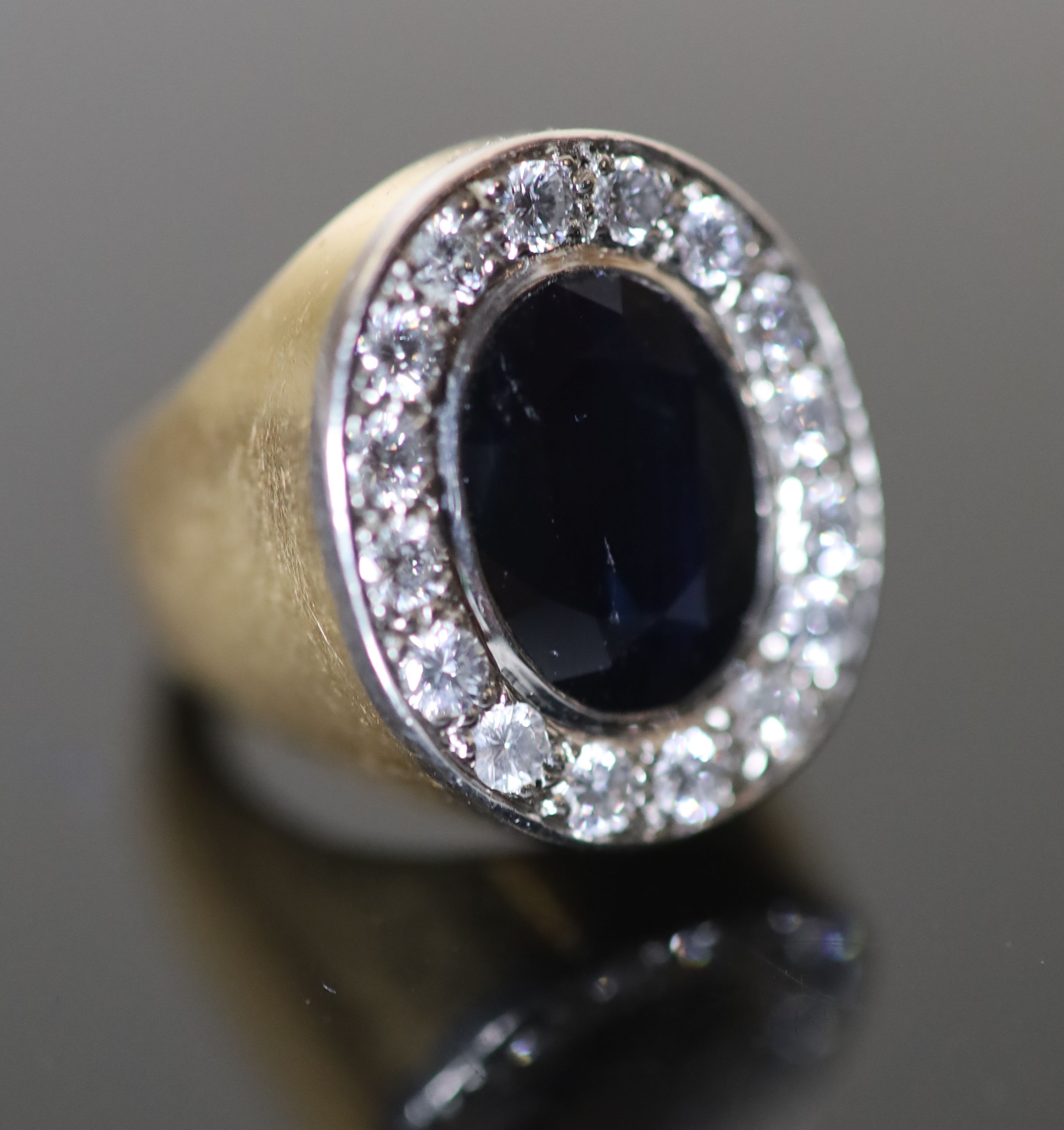 A modern continental 18ct gold (stamped 750), sapphire and diamond cluster set oval dress ring,